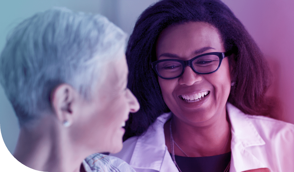 Female doctor smiling at female patient