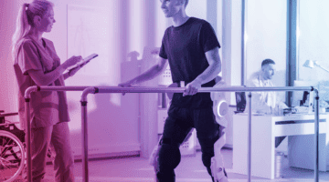 Patient in rehab using a robotic prosthetics leg.