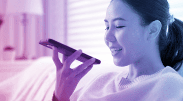 Young woman using an AI assistant on her phone.