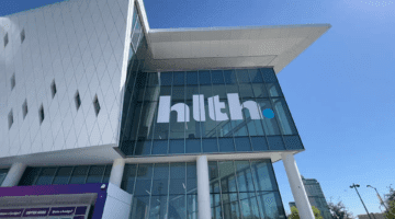Exterior of a conference center with the HLTH logo.