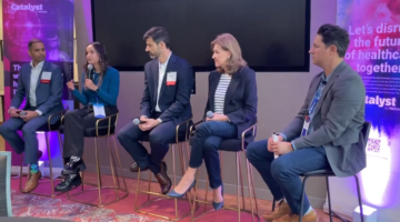 Panel of five people at a conference.